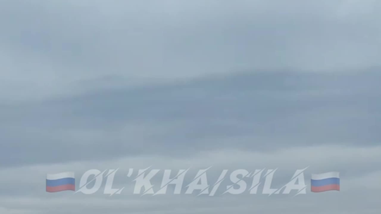 Russian soldiers watch a high-explosive aerial bomb fly toward its target.