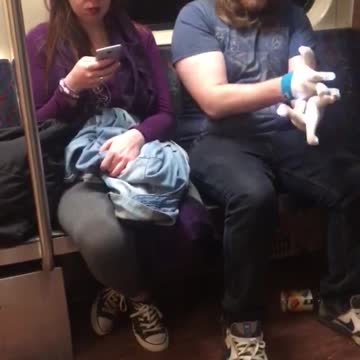 Guy blue shirt headphones white beanie gloving lights subway train
