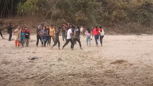 Picnic dance at river bank.