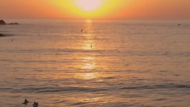 Sunset in the open sea from the top of a beach