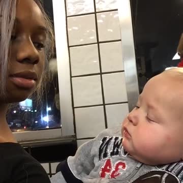 Cute Baby Stares At Woman Then Smirks