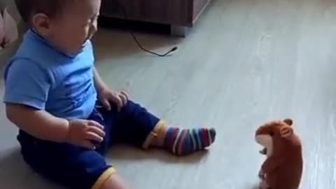 a fearful baby who wants to play with a toy