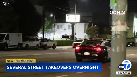 Crowd shatters rear window of LAPD vehicle after police arrive at street takeover