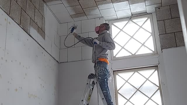 Time Lapse Spraying primer on acoustical tile