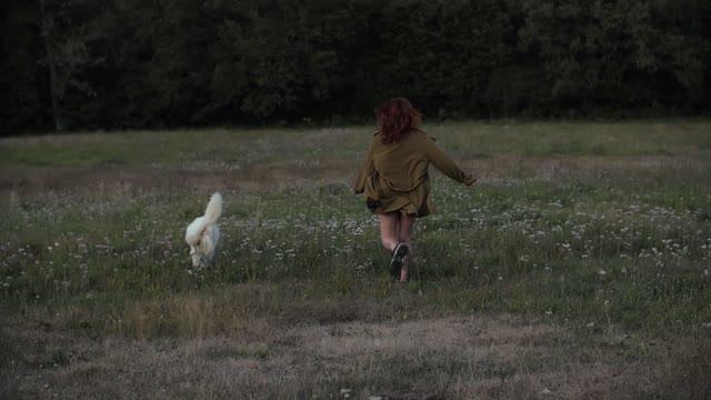 A dog running with the girl