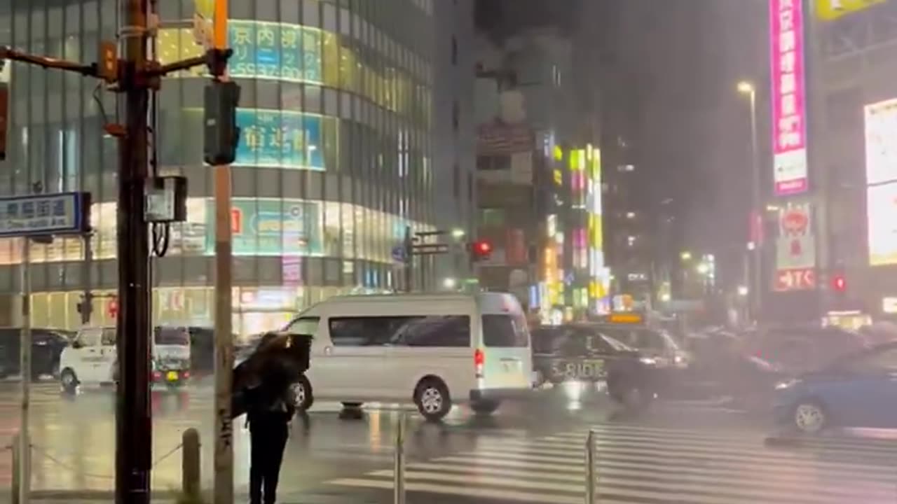 Water shoots out of a manhole near Shinjuku station after heavy rain hit Tokyo, Japan