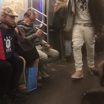 Guy with airpods raps out loud on subway train