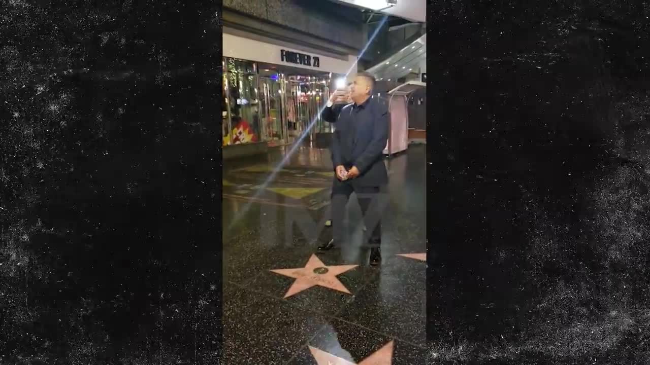 George Lopez pretends to urinate on Trump's Hollywood star.