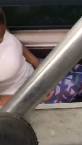 Guy red shirt massaging feet on subway downstairs