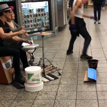 Subway drummers man white tank top wife beater dancing
