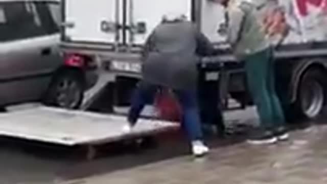 Watch: Trucker Uses Liftgate to Help Senior Get Into Car During Flood