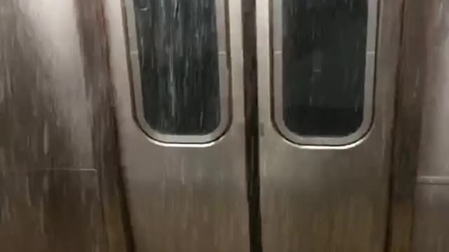 Flood waters fall in front of subway doors