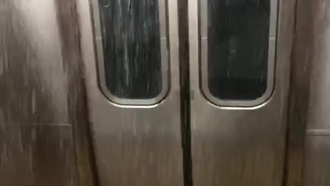 Flood waters fall in front of subway doors