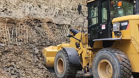 Cat loader scooping rock