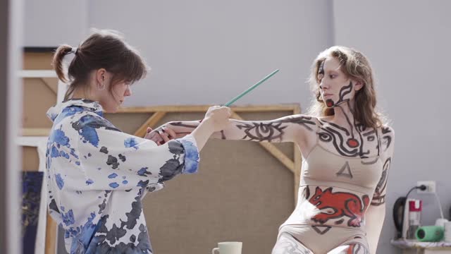 Artist Painting Hand of a Female Model