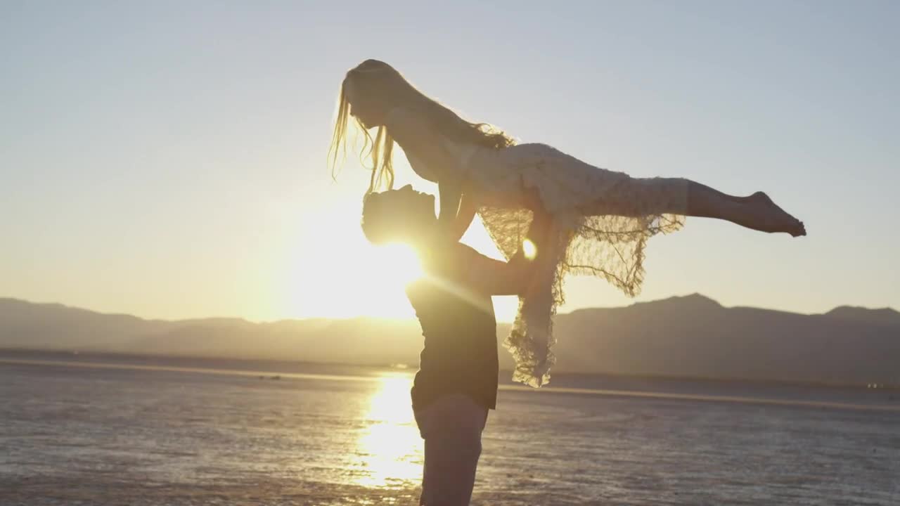 Cute Romantic Couple Dance On A Beach With Sunset