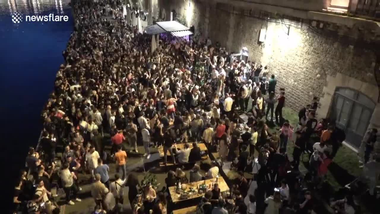 Hundreds celebrating music festival gather on banks of Paris river without social distancing