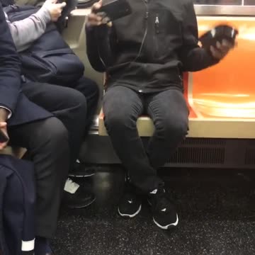 Man in black sweater with headphones singing