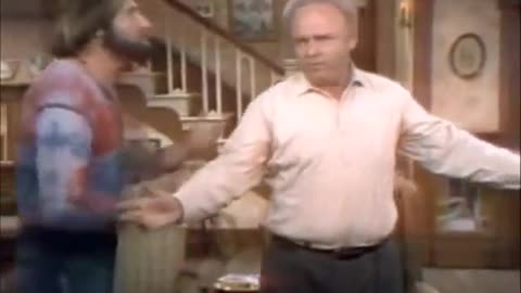 Archie Bunker showing Meathead he's a meathead, sings God Bless America