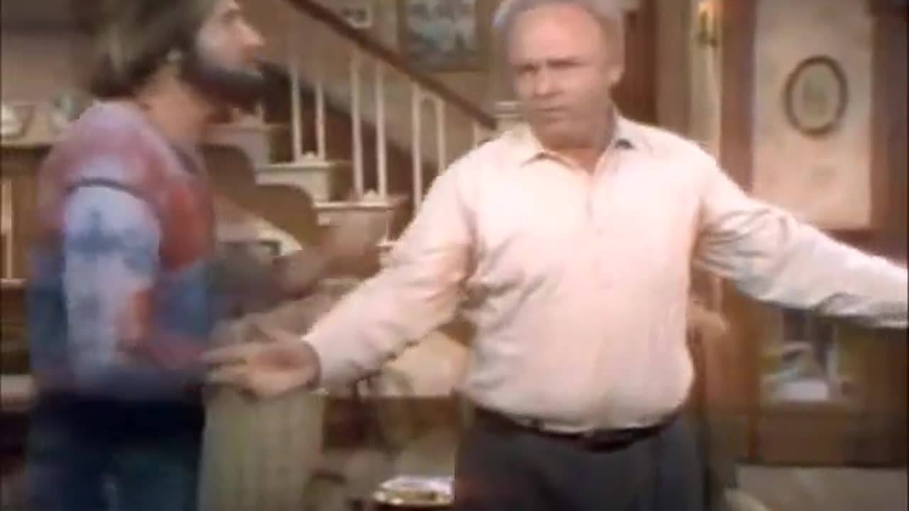 Archie Bunker showing Meathead he's a meathead, sings God Bless America