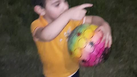 my son playing football in park