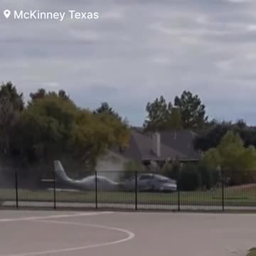 As a small plane overtakes the runway and crashes through a fence into a car