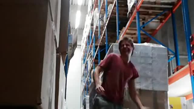 Red shirt guy handstand on cardboard box warehouse fail