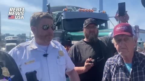 Policeman stops People's Convoy and threatens to arrest them