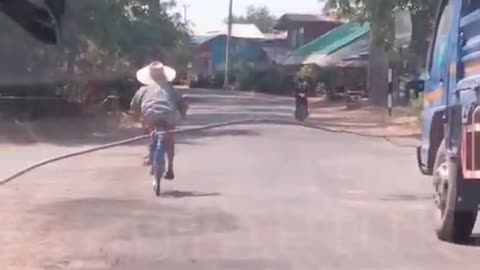 Truck Doesn't Want to Pass Grandma Carrying Stick on a Bike