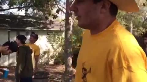 Nsfw yellow shirt cowboy hat breaks beer bong table