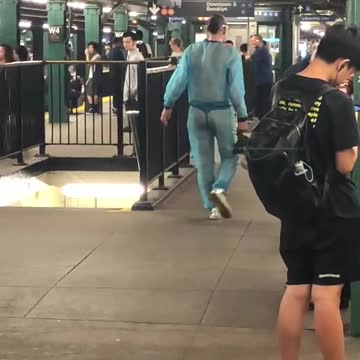 Guy subway station blue mesh see through clear jump suit outfit