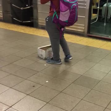 Man in red sweater playing harmonica