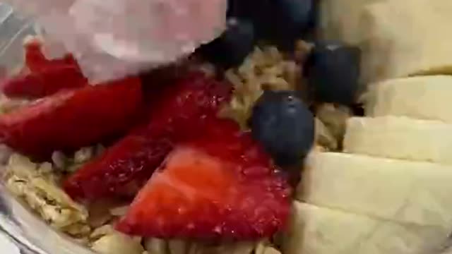 This full mug of ice cream comes with fruit.