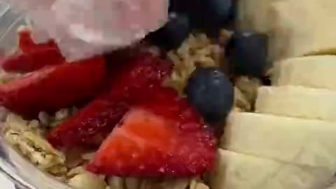 This full mug of ice cream comes with fruit.