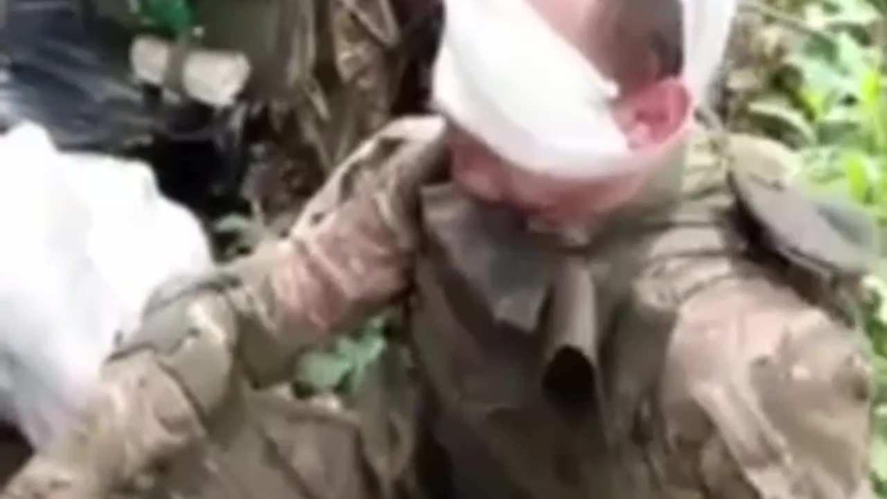 Medic Examining Russian Soldier's Eye Hole