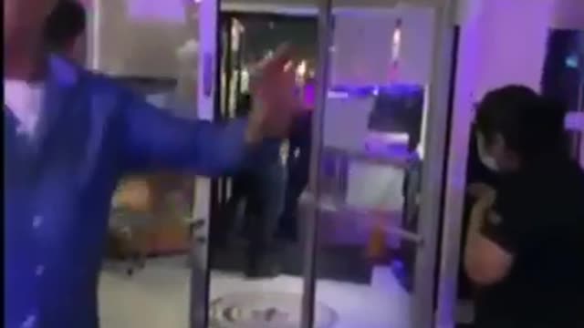 Female guard beats up people inside store in Asia.