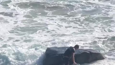 Surfer Struggles Against Pounding Waves