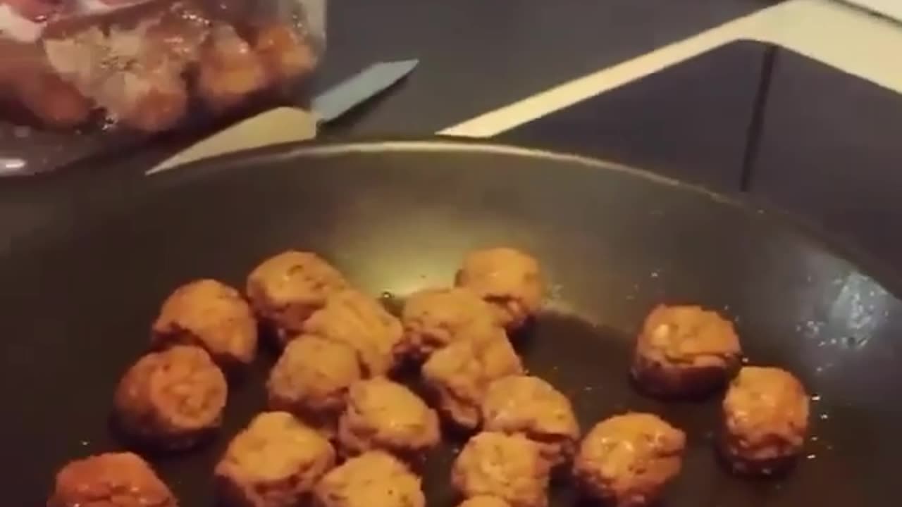 A sitting dog salivating because of frying bean cake