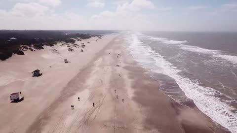 People walking along the coast