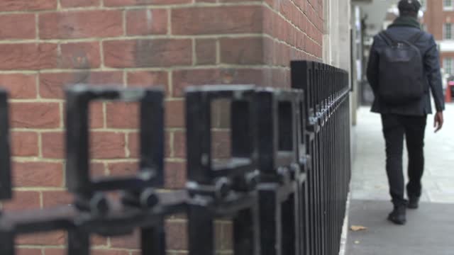 man walking close to wall