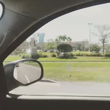 Guy drives by in large blue grey truck