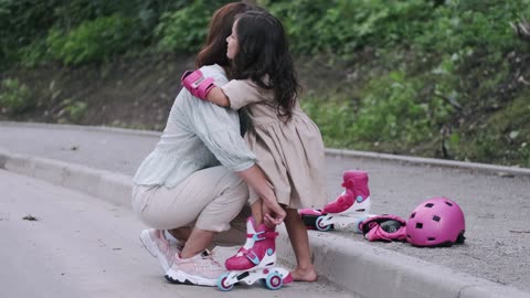 Mom Helping Daughter Wear Her Roller Skates