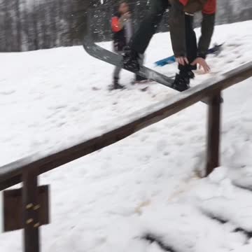 Guy kid in red jacket snowboard jump misses rail and slams face onto rail