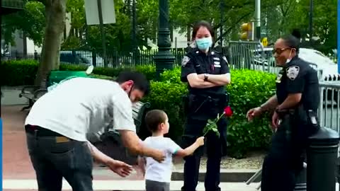 FATHER AND SON GIVE ROSES TO OFFICERS