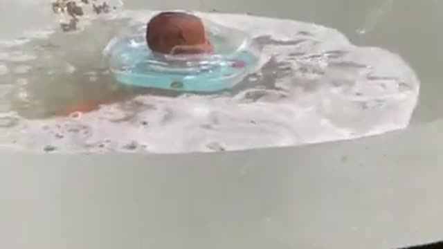 Cute baby in the hot pool.