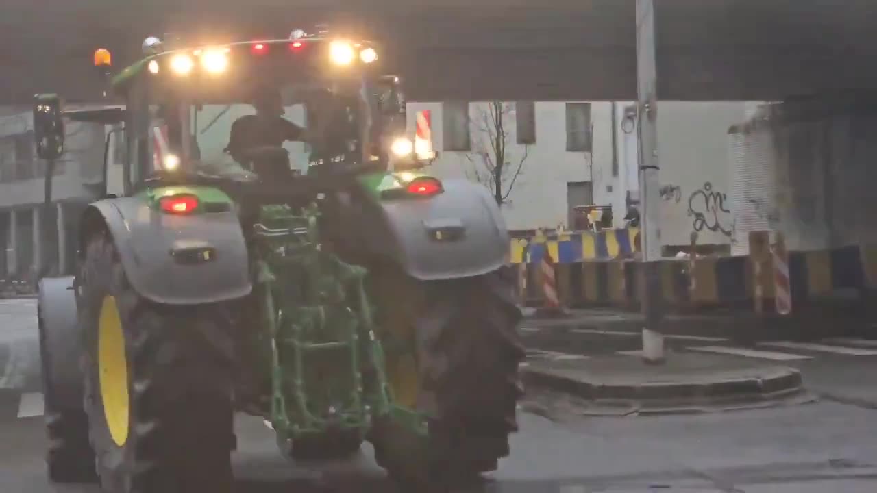 Belgian farmers breaking through barricades at the European Union HQ in Brussels