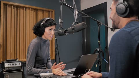 Presenters recording a podcast