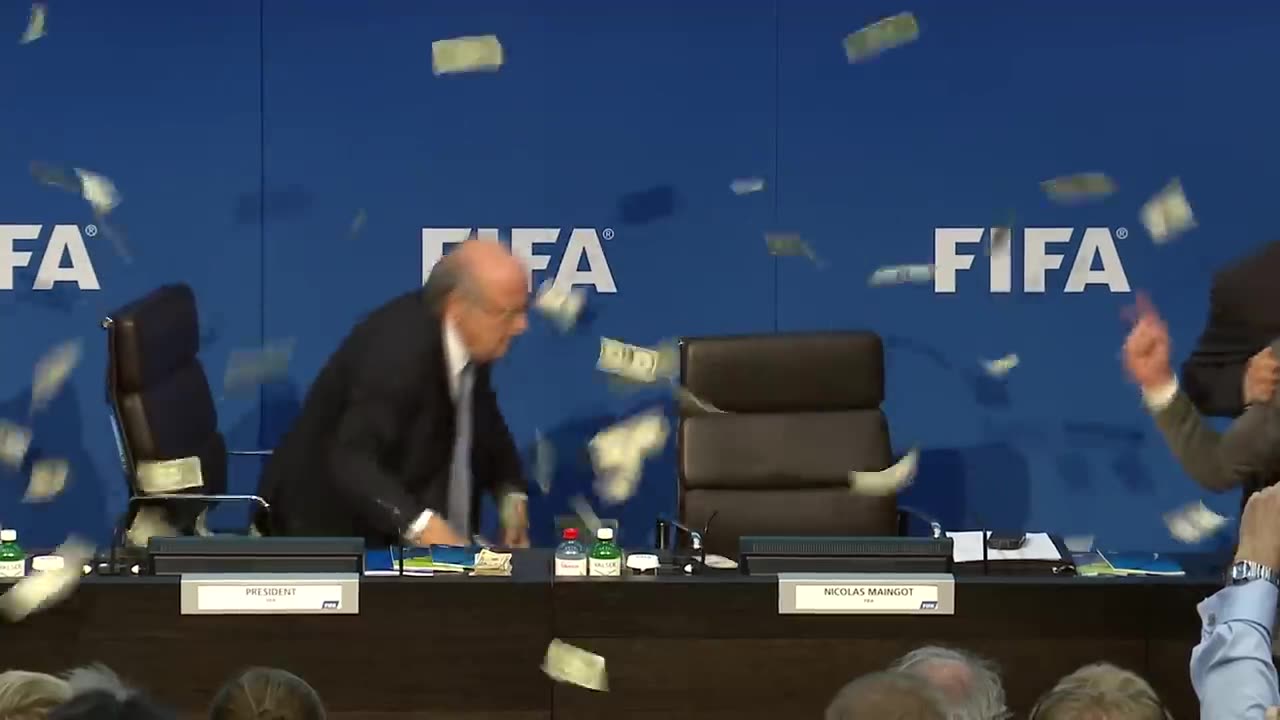 Moment Sepp Blatter was showered with fake dollar bills - BBC News