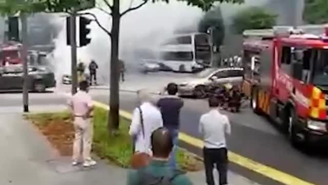 Burning Mercedes seen at junction outside Lau Pa Sat