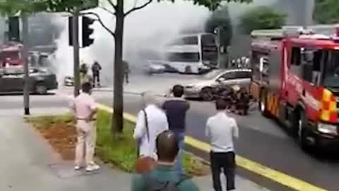 Burning Mercedes seen at junction outside Lau Pa Sat